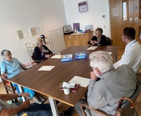 Five people sat around a table.