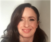 Lady with dark brown hair smiling to the camera
