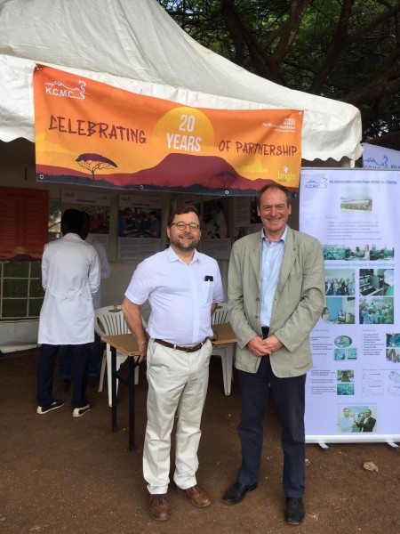 Two men stood in front of a gazebo.