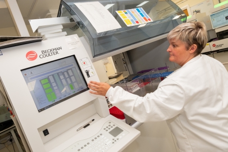 A person working on a large lab machine.