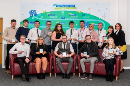 A large group of people each holding an award.