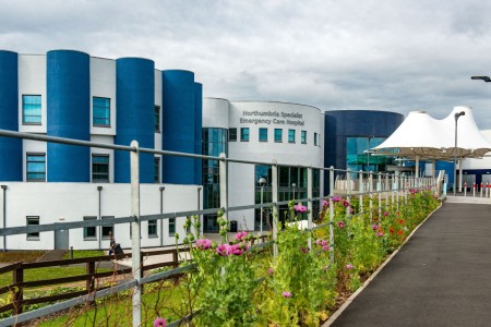 Outside view of NSECH hospital on a sunny day