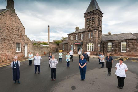 A large group of people stood socially-distanced outside of Berwick Infirmary.