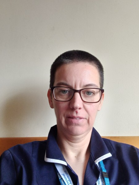 Portrait of a woman wearing a nurses uniform.
