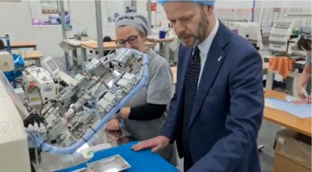 A man and a woman looking at a piece of machinery.