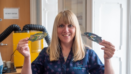 Lady holding two plastic fish