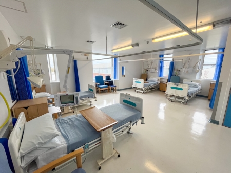 An empty ward with hospital beds