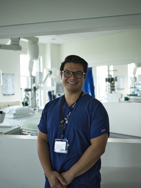 A portrait of a male wearing scrubs.