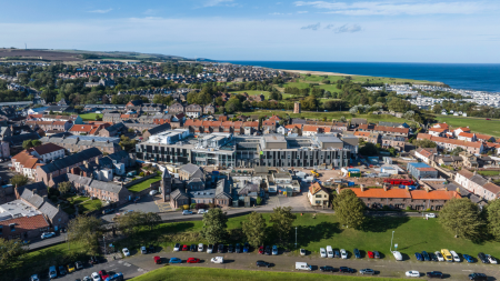A view from the air across a town with the under-construction hospital in the centre.