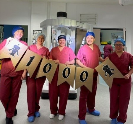 Northumbria Healthcare robotics team standing with a sign that reads "1000"