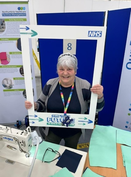 A woman posing for a photo holding a selfie frame