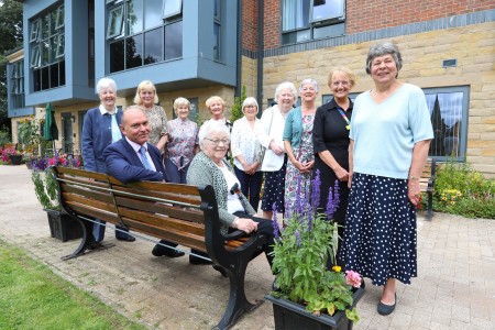 A group of women and a man outside a hospital.