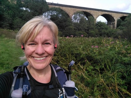 A selfie of a woman with blonde hair out on a run.