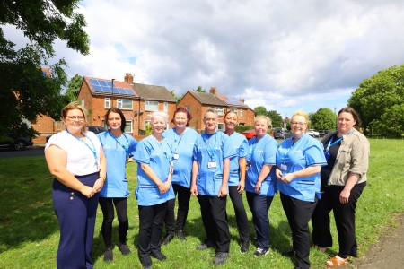 The Care Northumbria staff team standing together outside.