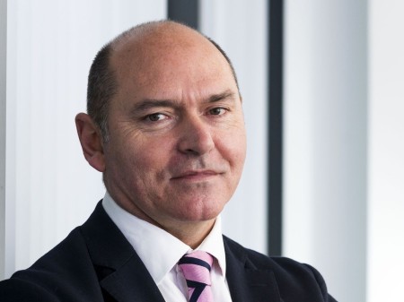 A portrait of a male. He is wearing a suit.
