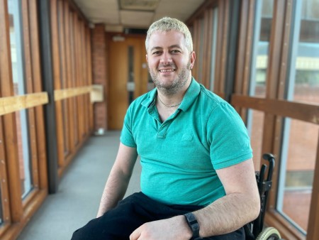 A man with blonde hair sat in a wheelchair.