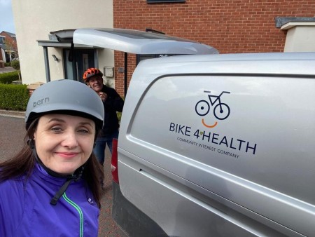 A selfie of a woman standing next to a van.