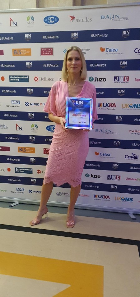 A woman holding an award.