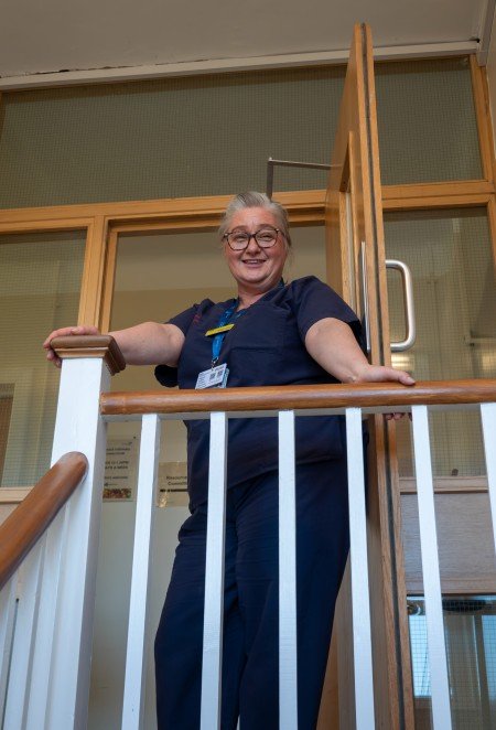 Anna Wood posing at the top of the stairs.