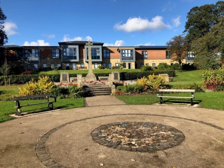 A garden with a war memorial statue.