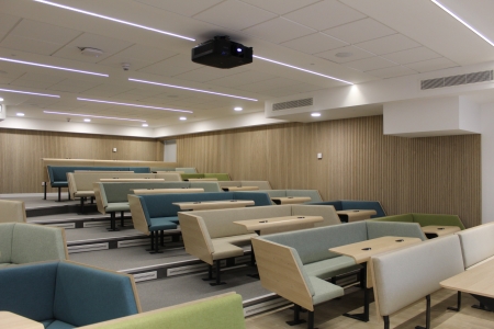 A lecture theatre with modern seating and tables 