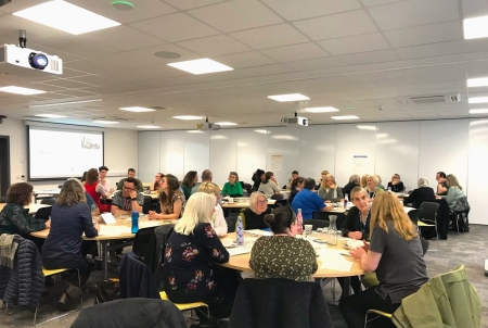 Groups of people sat at tables during Better Together events.