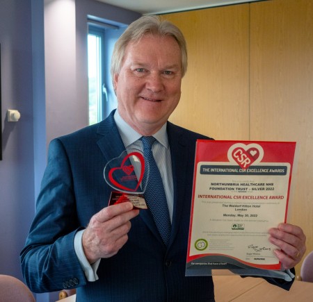 Photograph of a man with an award.